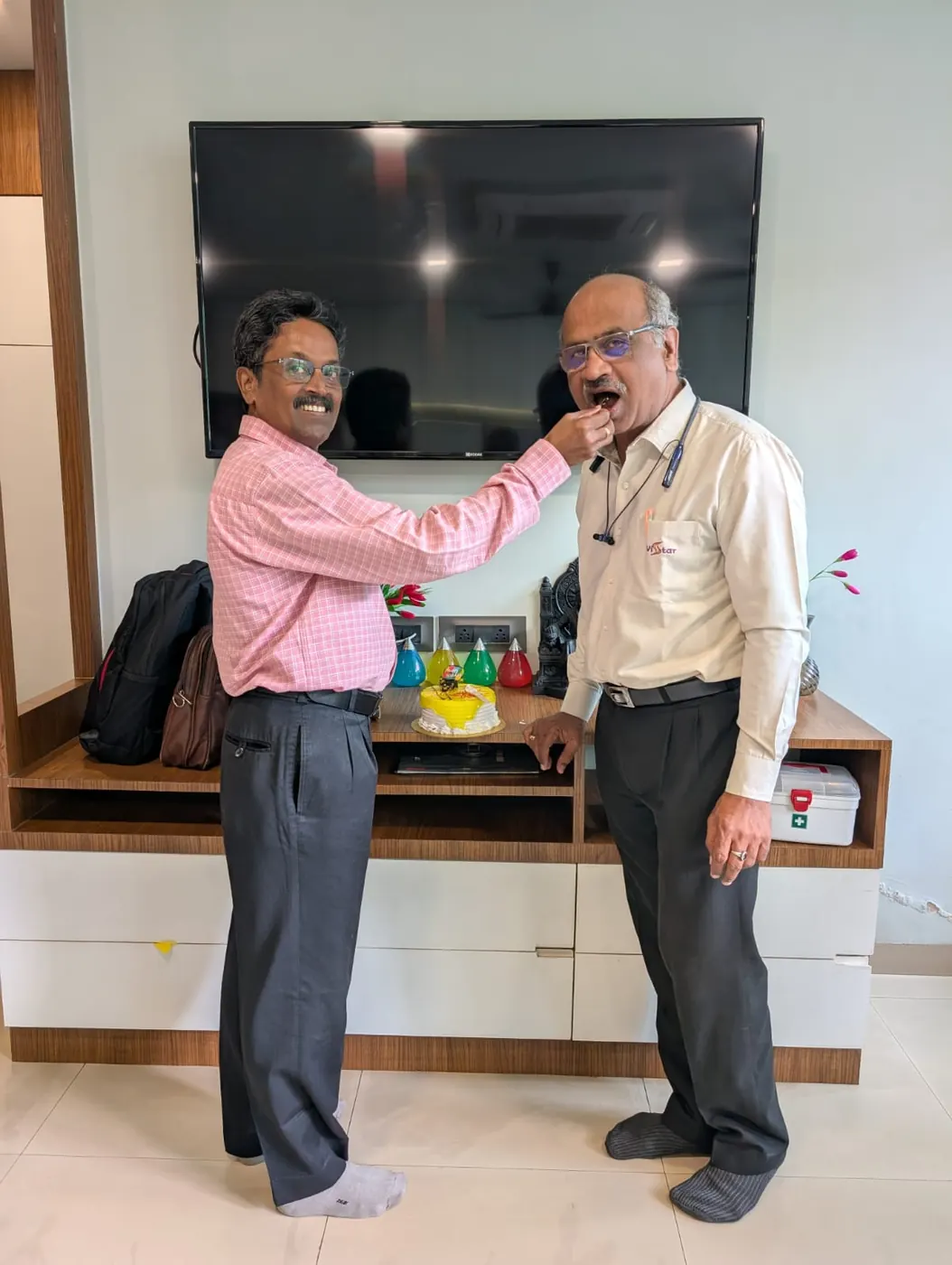 Two Vistar colleagues sharing cake at an office celebration