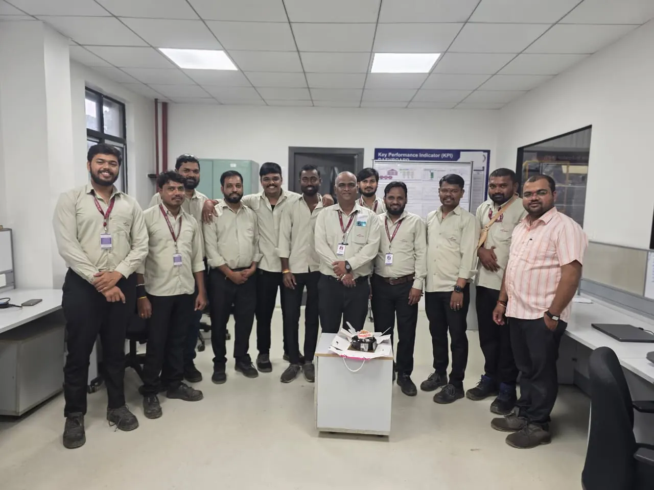 The operations team gathered around a cake in the office