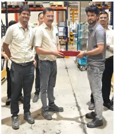 A recognition award being handed over between colleagues