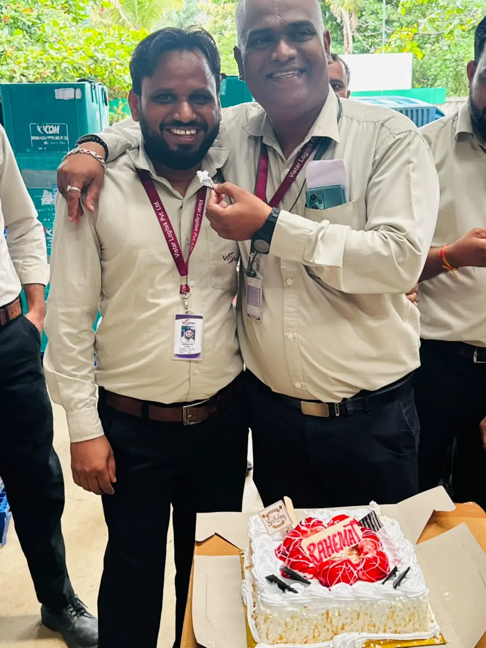 Two team members celebrating together outside the facility
