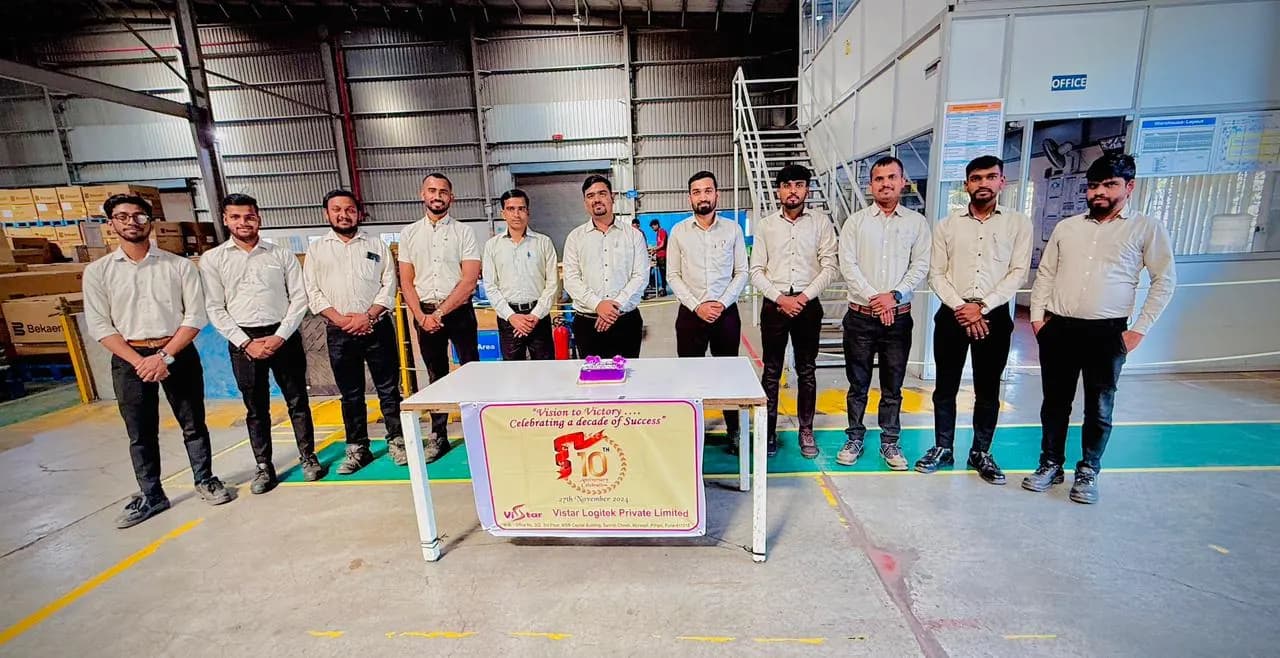 The full warehouse shift team lined up across the operations floor
